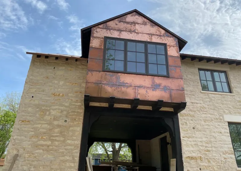 Copper metal panel facade on a stone building for Roof Repair in Las Cruces